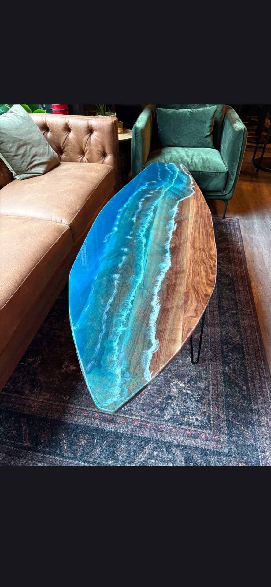 Ocean-resin table between chesterfield and velvet armchair