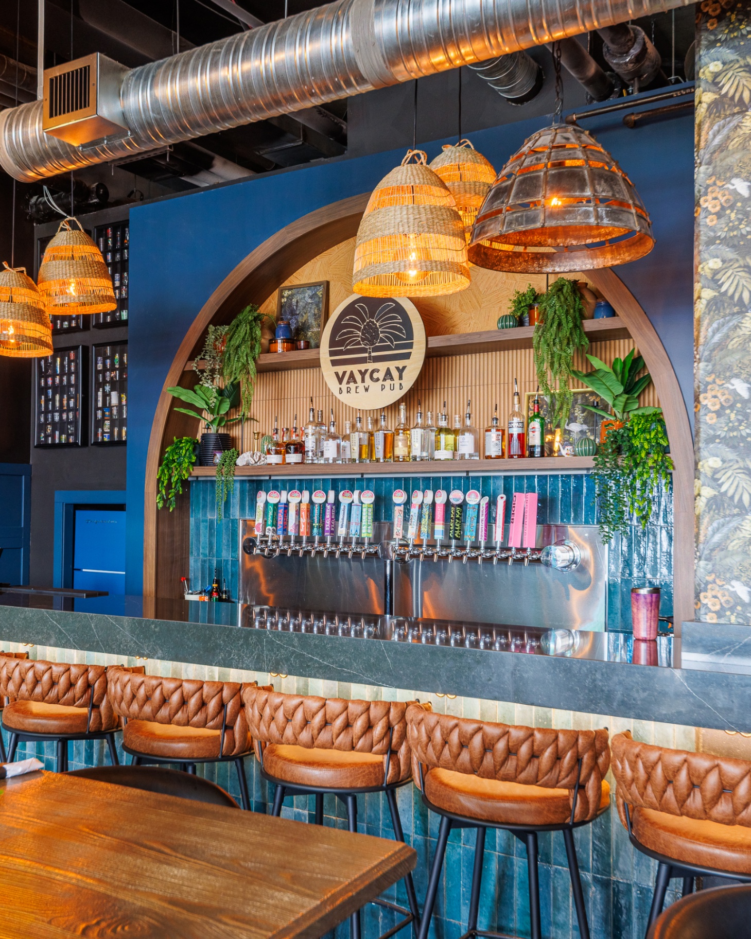 Vaycay Brew Pub downstairs bar with arched feature wall and tap lineup