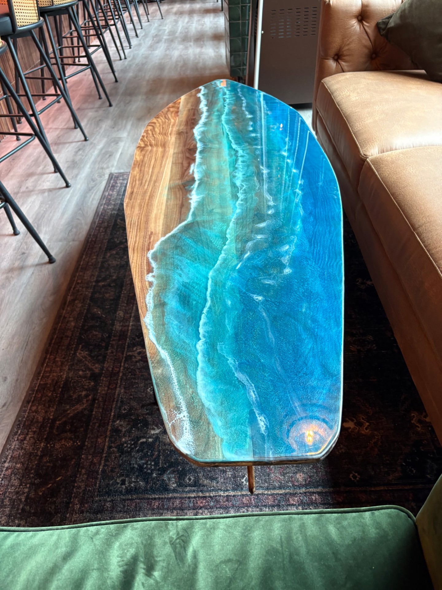 Custom ocean-resin live edge coffee table in the upstairs lounge